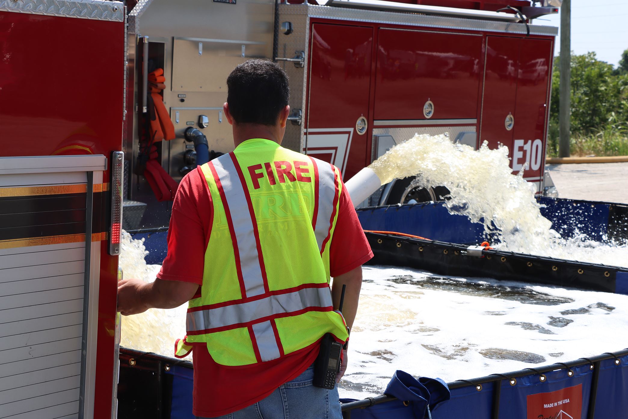 A firefighter monitors a fill site during the water shuttle operation