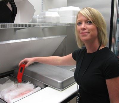 Woman checking the temperature of food